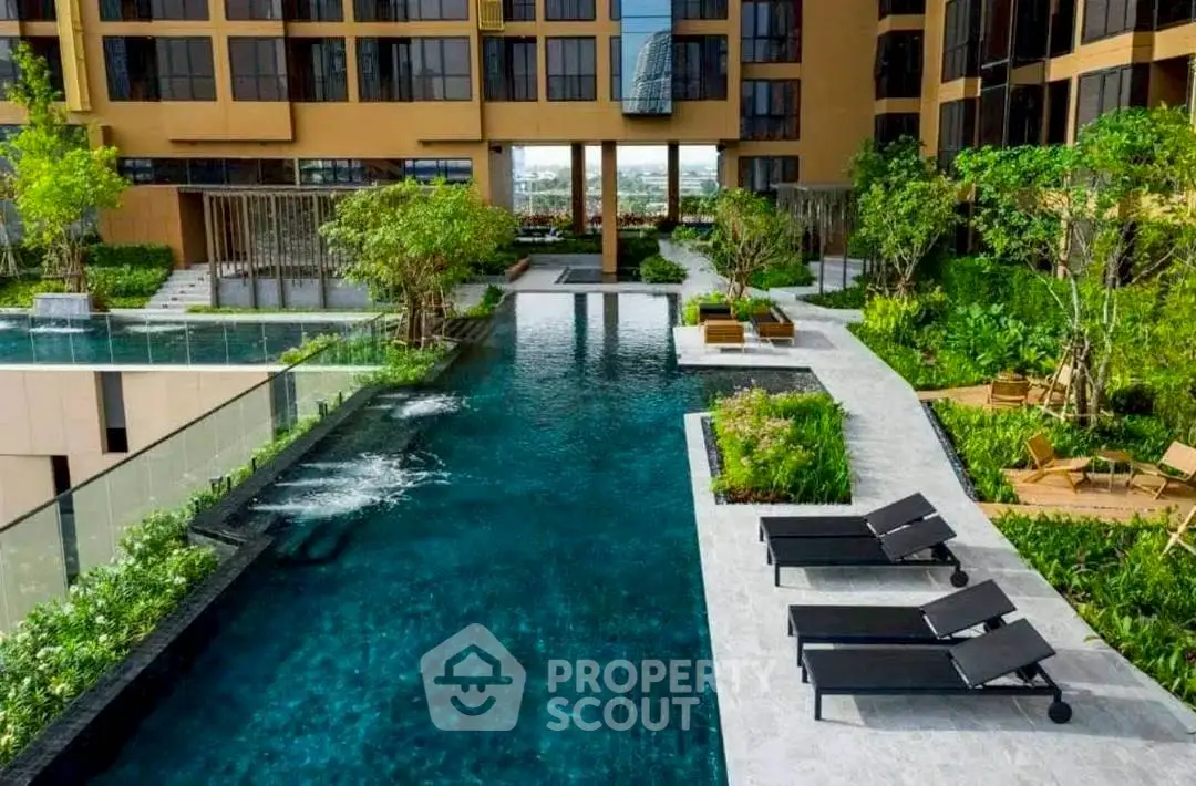 Luxurious apartment complex with stunning pool and lush greenery