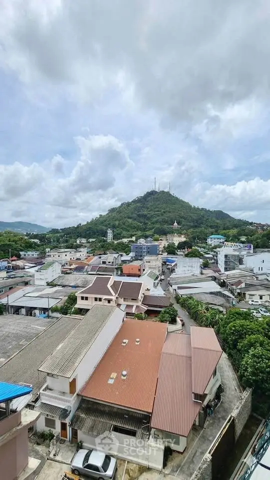 Scenic view of a residential neighborhood with lush green hills in the background, perfect for tranquil living.