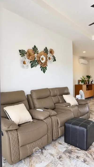 Stylish living room with modern recliner sofa and elegant wall decor, perfect for relaxation and comfort.