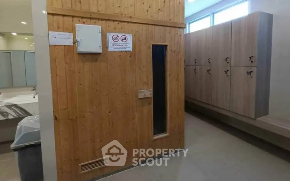 Modern gym locker room with sauna and lockers, ideal for fitness enthusiasts seeking relaxation and convenience.
