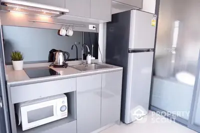 Modern compact kitchen with sleek appliances and stylish cabinetry