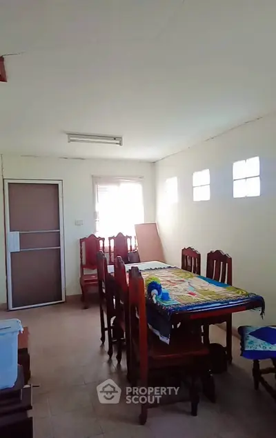 Spacious dining area with natural light and elegant wooden furniture.