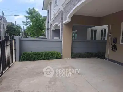 Spacious modern driveway with elegant facade and lush greenery in suburban home