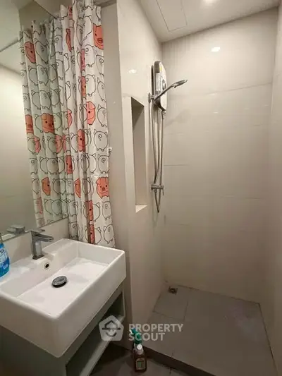 Modern bathroom with shower and sink in compact design