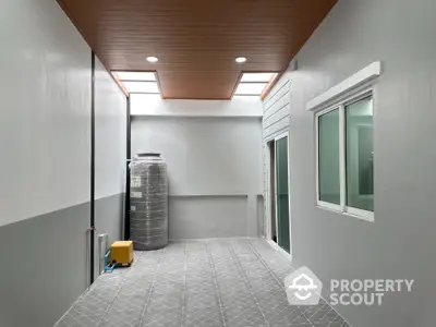 Modern enclosed patio with skylights and tiled flooring