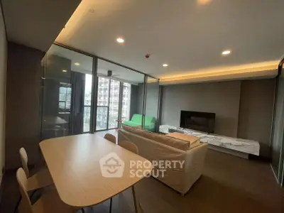 Modern living room with sleek furniture and city view balcony