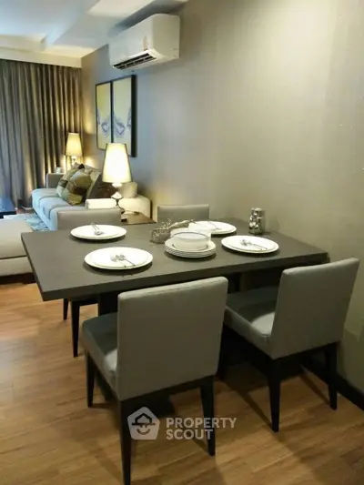 Modern dining area with elegant table setting and cozy living room ambiance.