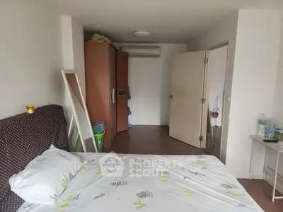 Cozy bedroom with modern decor and ample storage space, perfect for comfortable living.