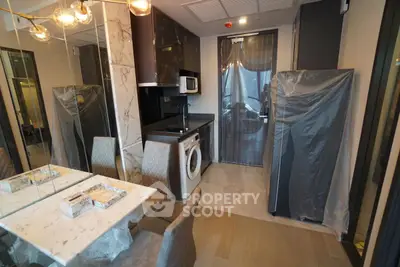 Modern kitchen with marble accents and integrated appliances in a stylish apartment.