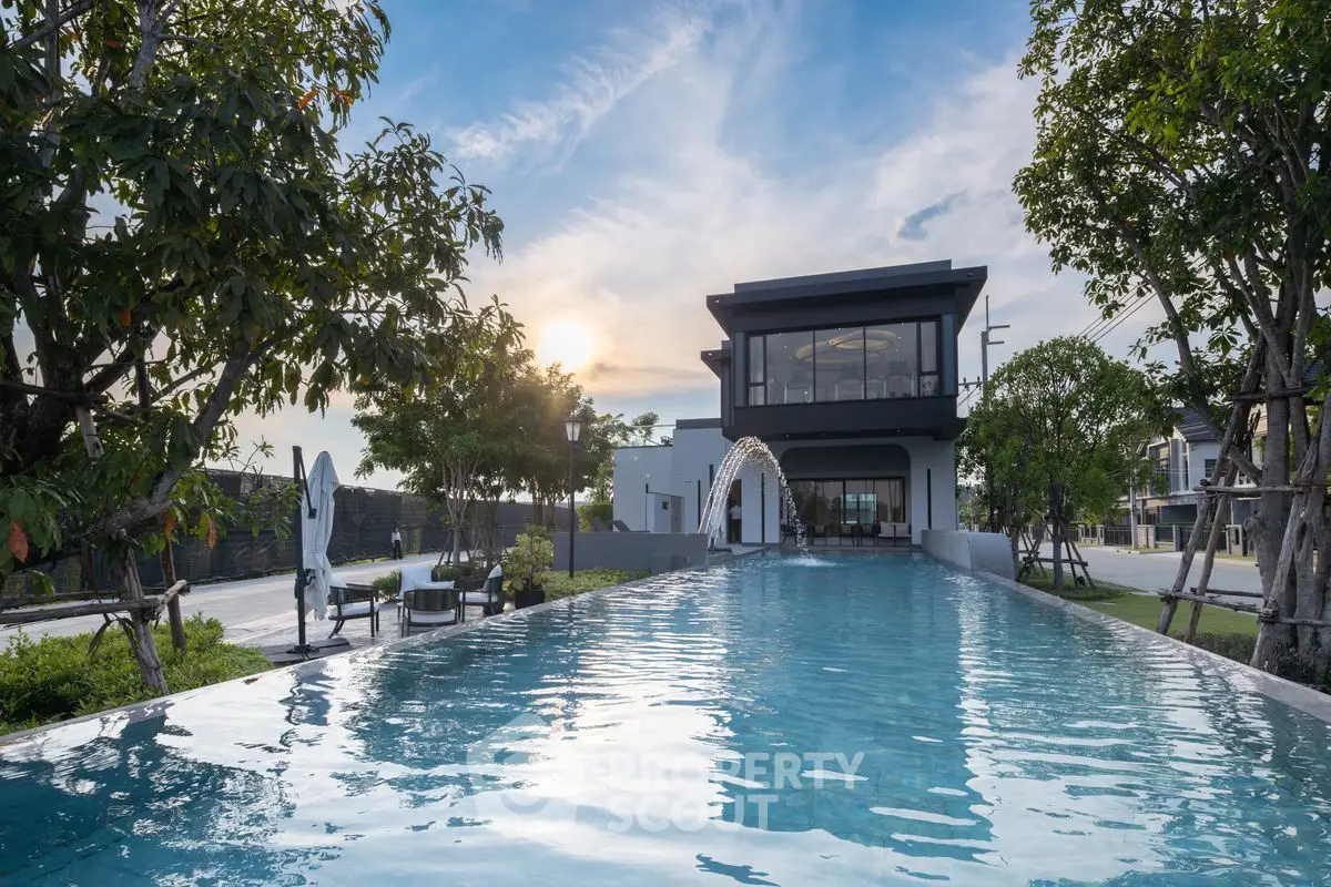 Luxurious modern home with stunning infinity pool and lush garden view.