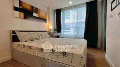 Modern bedroom with stylish decor and large window in a contemporary apartment.