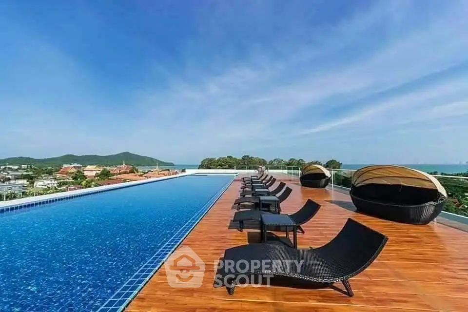 Luxurious rooftop pool with stunning panoramic views and stylish lounge chairs.