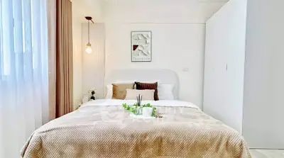 Cozy and stylish bedroom with modern decor and soft lighting, perfect for relaxation.
