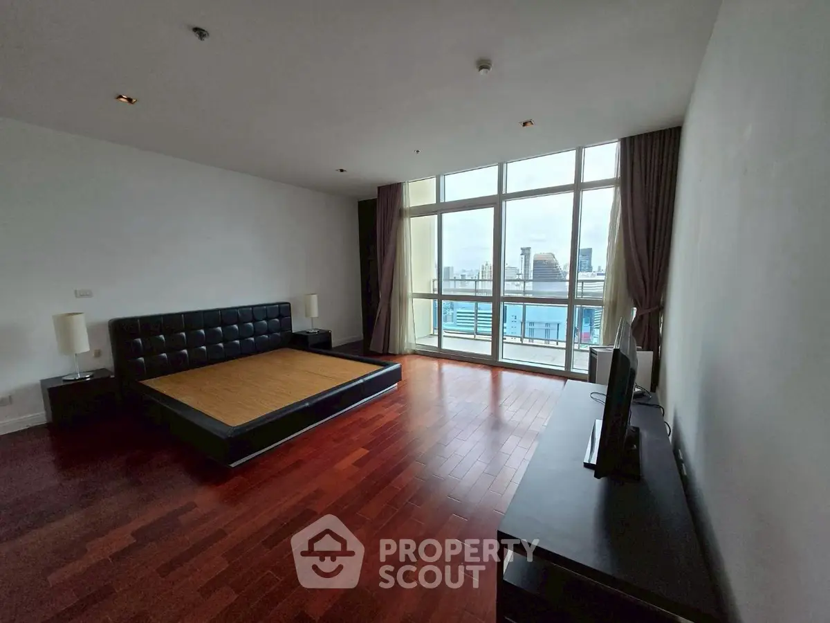 Spacious bedroom with city view and modern furnishings