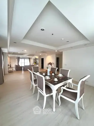 Spacious open-plan living and dining area with elegant furniture and modern decor.