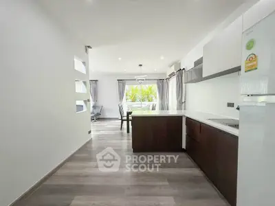 Spacious open-plan kitchen and dining area with modern design and natural light.