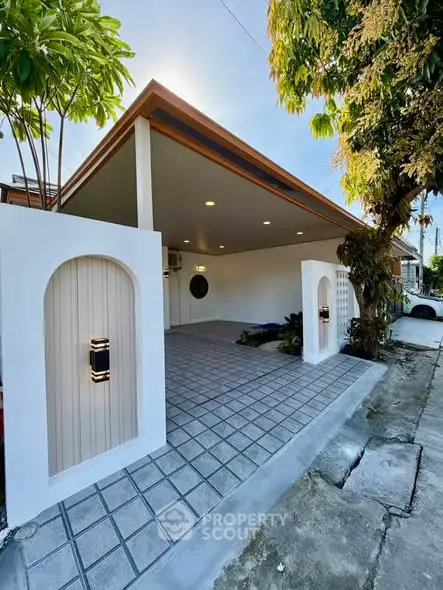 Modern carport with sleek design and stylish lighting in a contemporary home exterior.