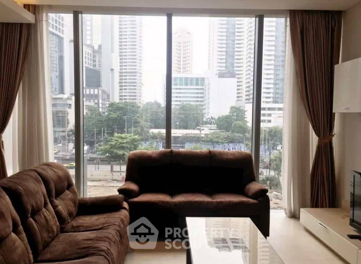 Spacious living room with large windows offering stunning city view
