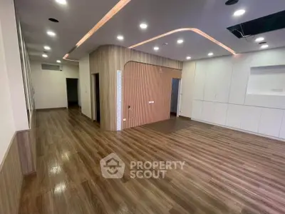Spacious modern living room with elegant wood flooring and recessed lighting