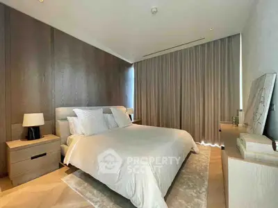 Luxurious modern bedroom with elegant decor and soft lighting, featuring a cozy bed and stylish furnishings.