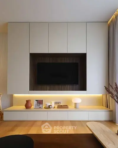Modern living room with sleek built-in TV unit and ambient lighting