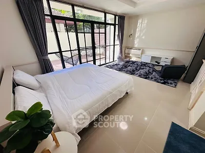 Spacious bedroom with large windows and modern decor