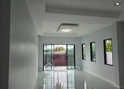 Spacious modern living room with large windows and natural light