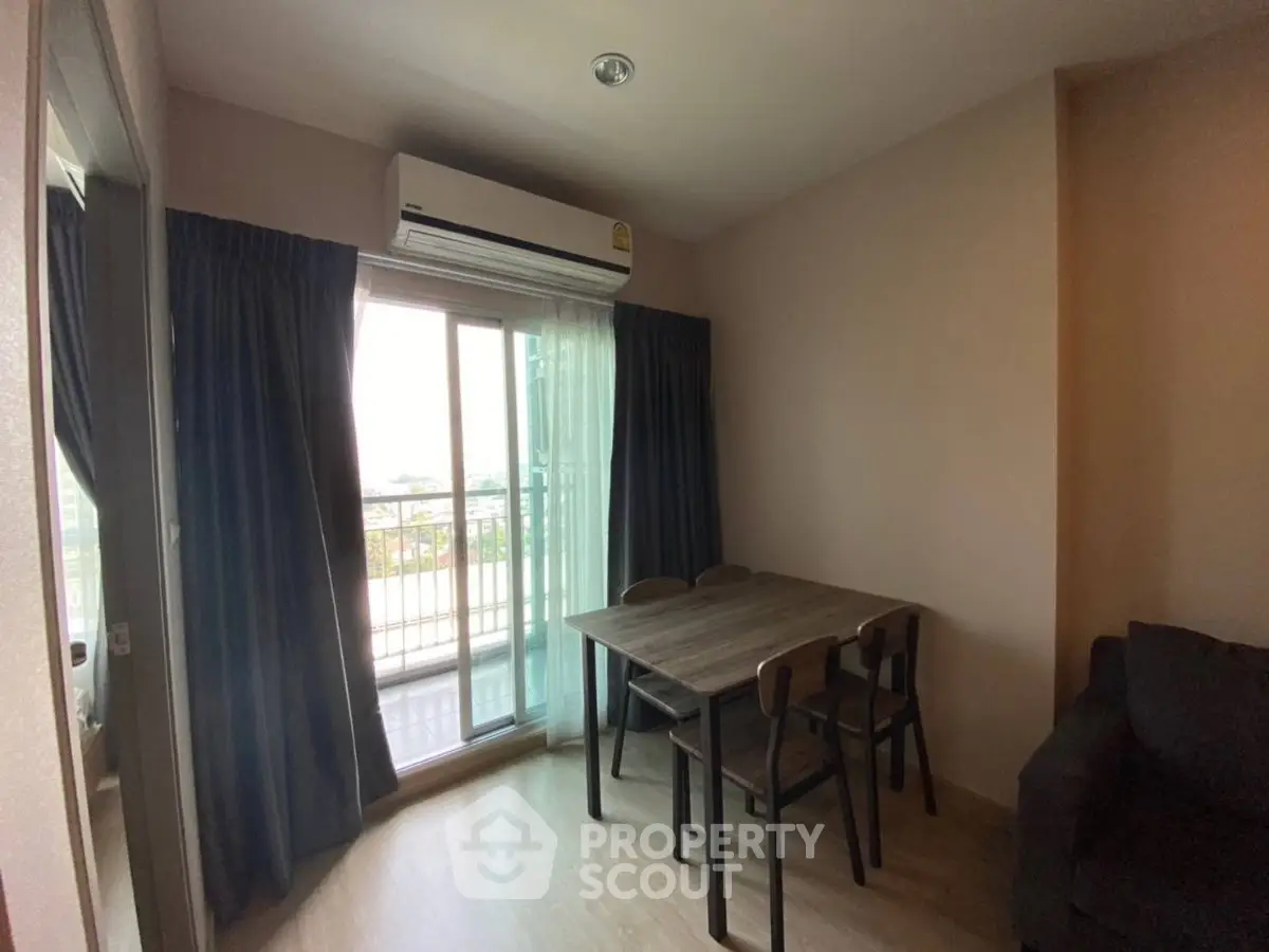 Cozy living room with balcony access and dining area in modern apartment