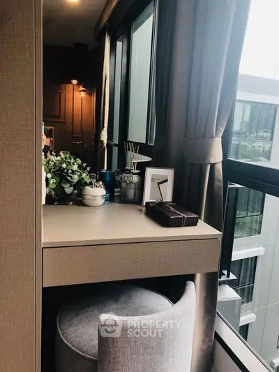 Stylish study nook with modern decor and large window view in urban apartment.