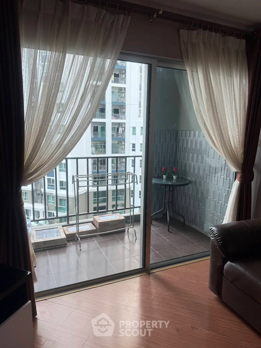 Charming apartment with cozy balcony and city view, perfect for relaxation and enjoying urban living.