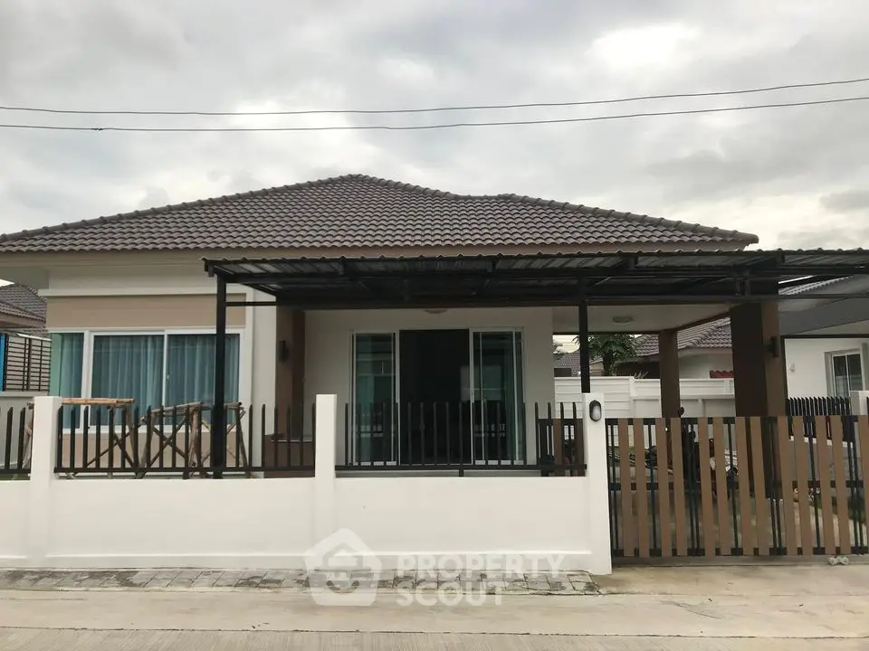 Charming single-story house with modern design and spacious front yard
