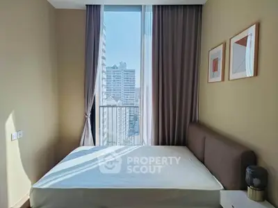 Modern bedroom with large window offering city view, featuring minimalist decor and natural light.