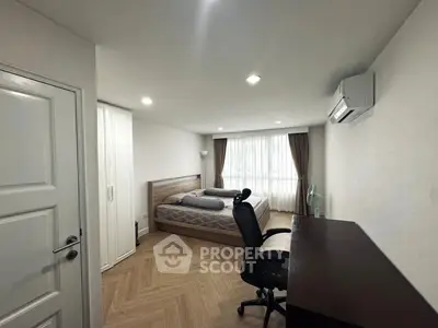 Spacious bedroom with modern furnishings and natural light