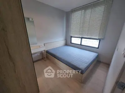 Cozy minimalist bedroom with wooden furniture and large window blinds