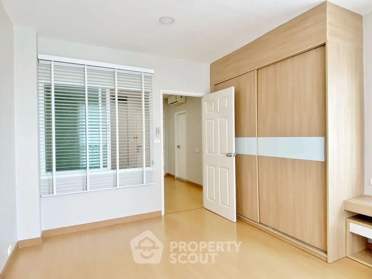 Spacious bedroom with built-in wardrobe and natural light