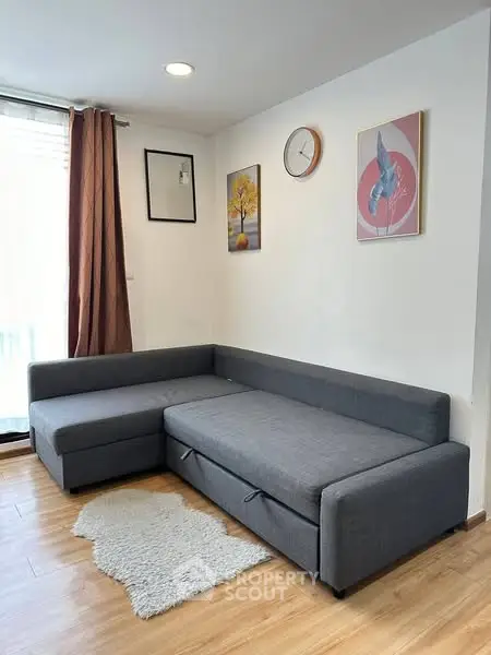 Modern living room with stylish gray sectional sofa and elegant decor