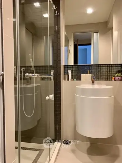 Modern bathroom with sleek fixtures and glass shower enclosure
