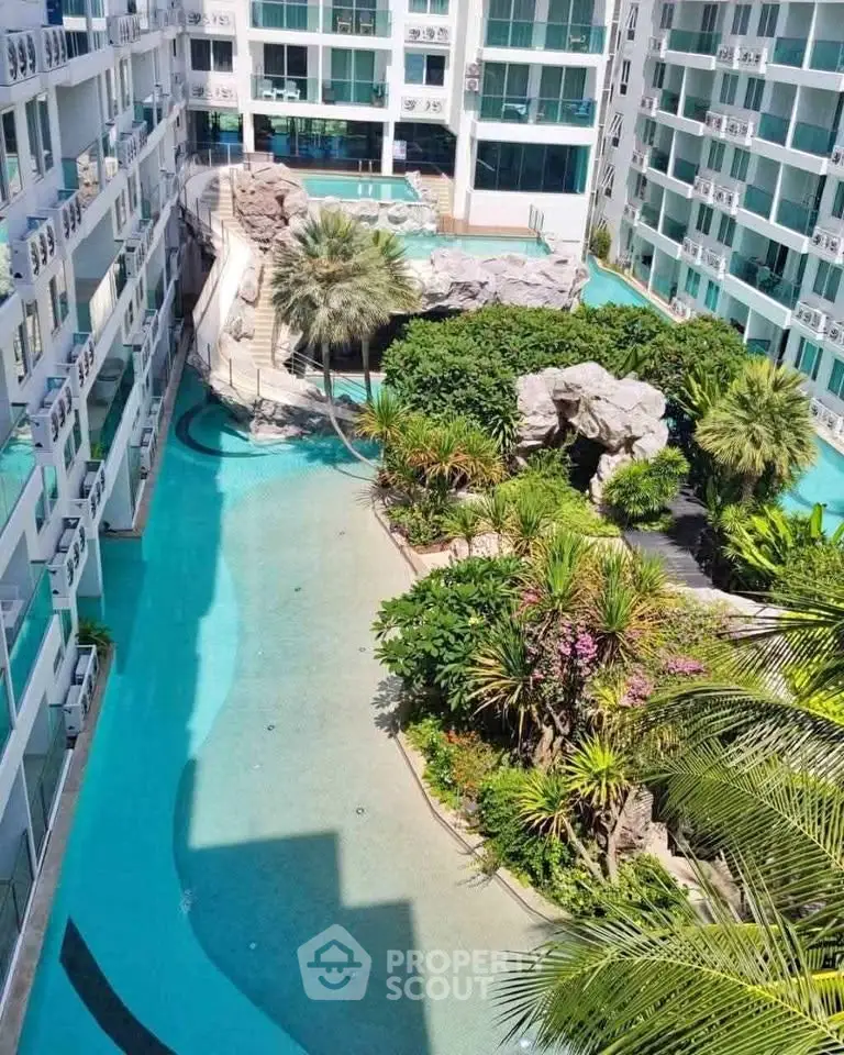 Luxurious condominium with stunning pool and lush garden view