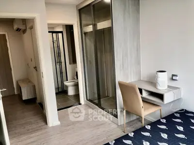 Modern apartment interior with study area and bathroom, featuring sleek design and neutral tones.