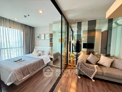 Modern bedroom with glass partition and cozy living area in stylish apartment