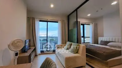 Modern studio apartment with open layout and city view balcony.