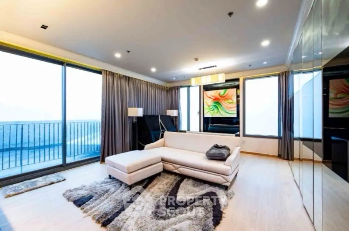Spacious modern living room with large windows and stylish decor