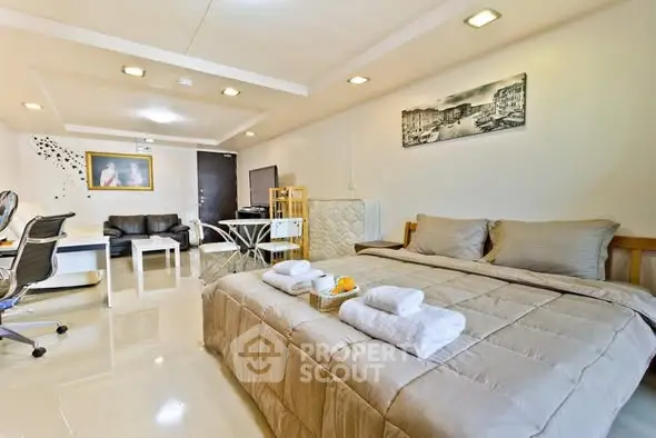 Spacious modern studio apartment with cozy bed and stylish decor