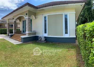 Charming single-story home with lush green lawn and modern exterior design.
