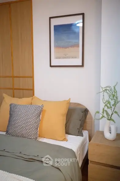 Cozy bedroom with stylish decor and wooden accents, perfect for relaxation.
