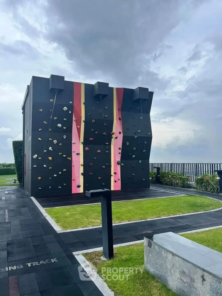 Modern rooftop with climbing wall and scenic view, perfect for active lifestyle enthusiasts.