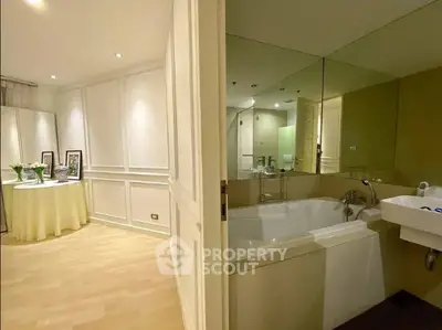 Elegant bathroom with large bathtub and stylish decor in modern apartment.