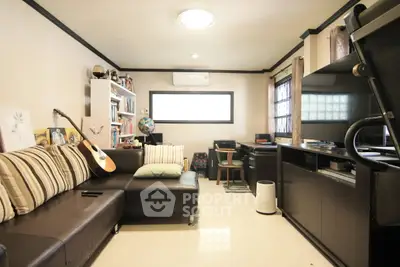 Cozy living room with modern furniture and entertainment setup, perfect for relaxation and leisure.