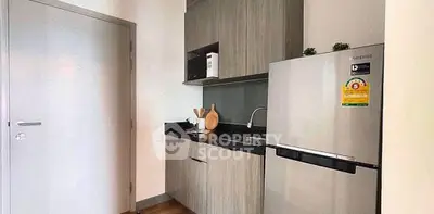 Modern kitchen with sleek cabinets and stainless steel fridge