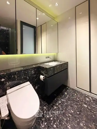 Luxurious modern bathroom with sleek design and high-end fixtures, featuring elegant marble flooring and walls.